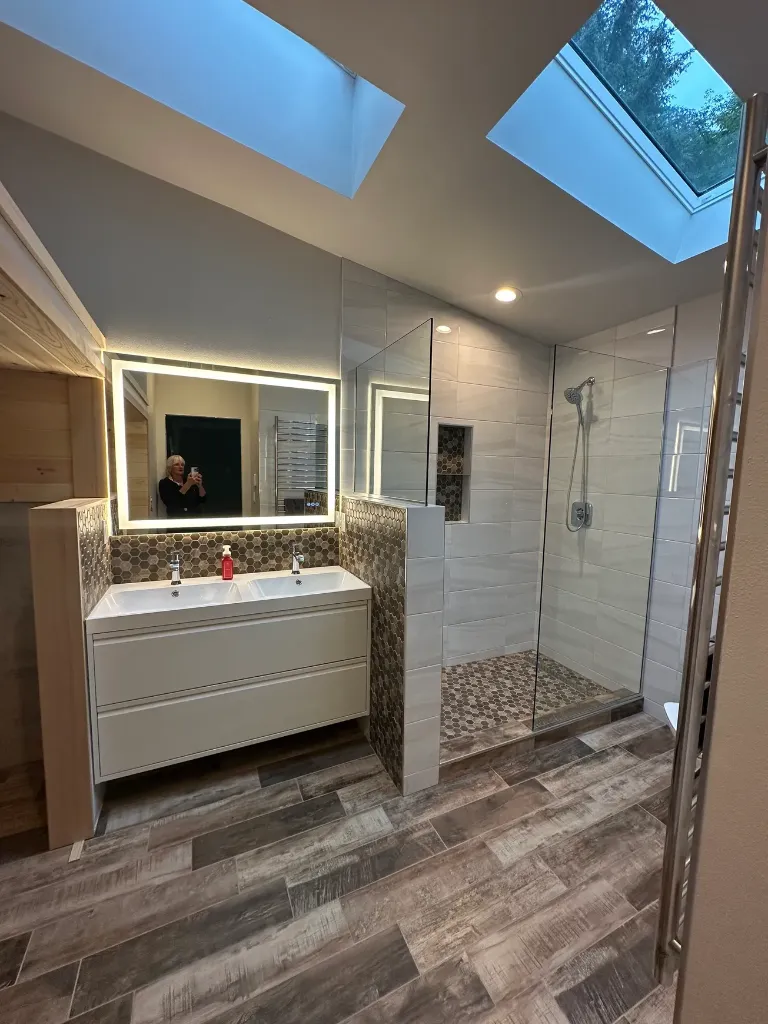 Primary bathroom remodel with walk-in shower and skylight by Beach Built LLC
